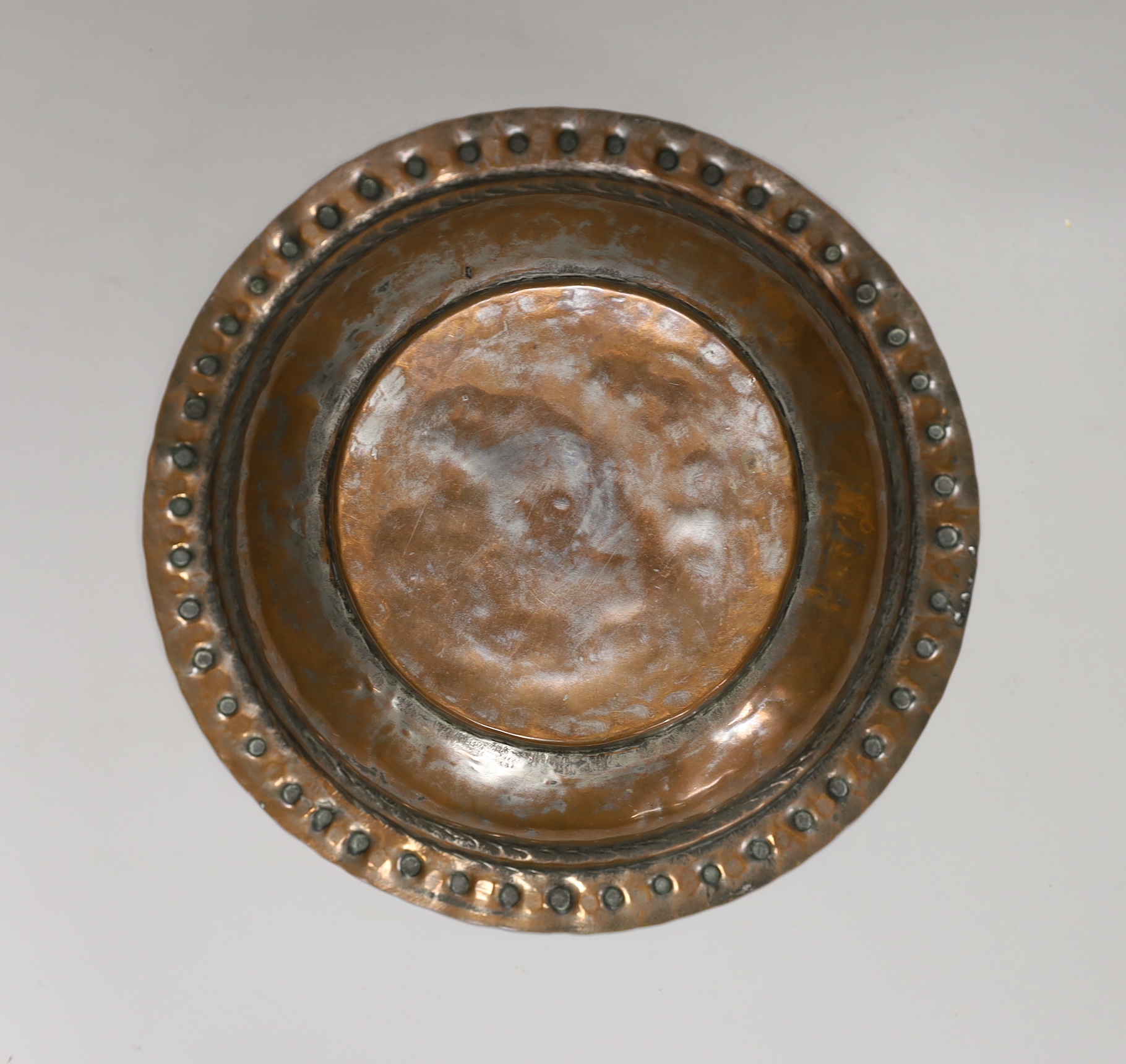 A Middle Eastern tinned copper bowl with embossed rim, 24cm in diameter